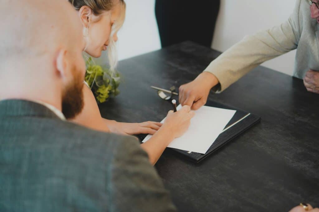 a talent contract is shown by a woman towards a man