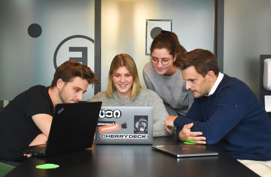 workers of PR in entertainment industry looking intently at a computer